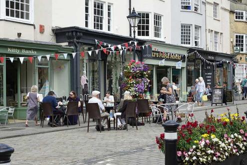 People enjoying the cafes and shops within a smaller village